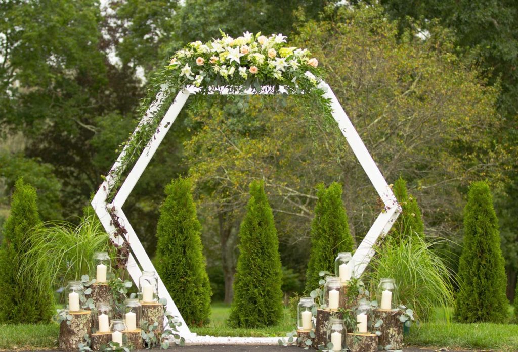 Wedding Ceremony - Arch with large floral arrangement